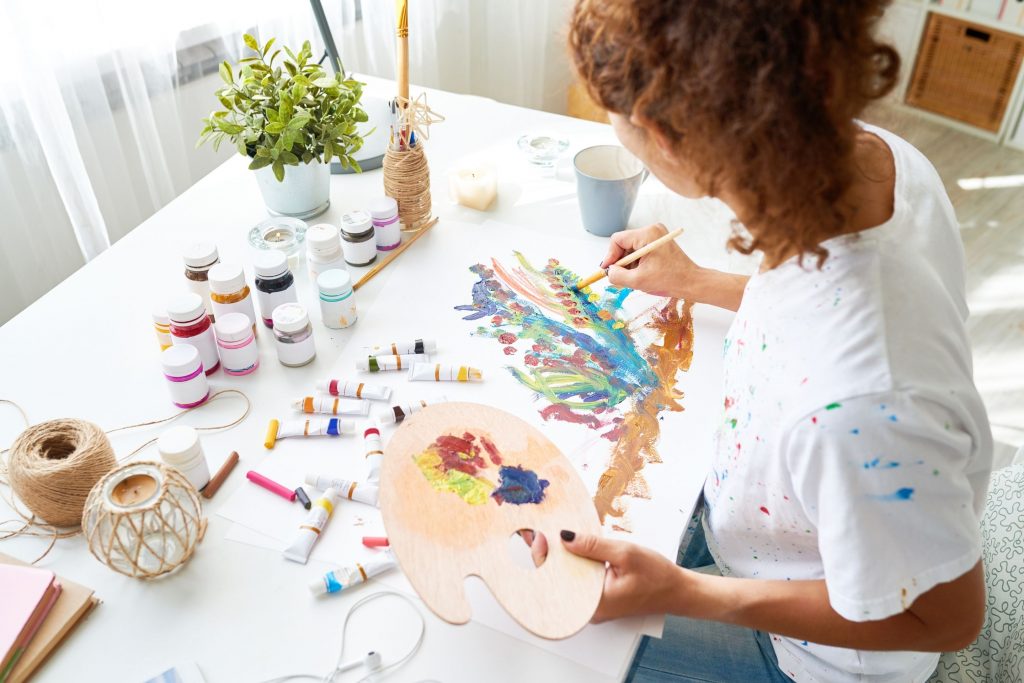 A woman painting to reduce stress